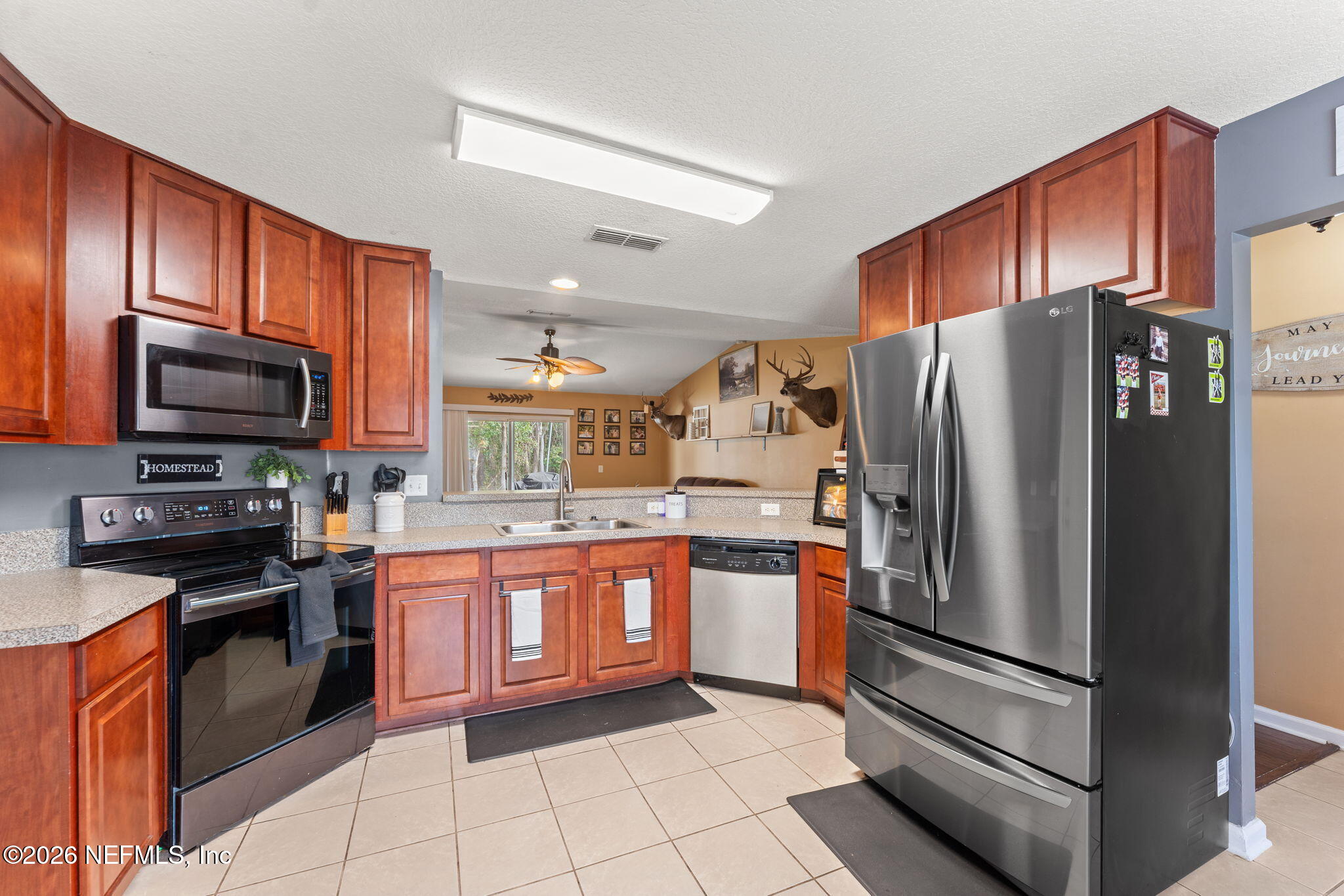 45212 Ingleham Circle Callahan, FL 32011 - Photo 5 of 35 a kitchen with stainless steel appliances granite countertop a refrigerator stove and oven