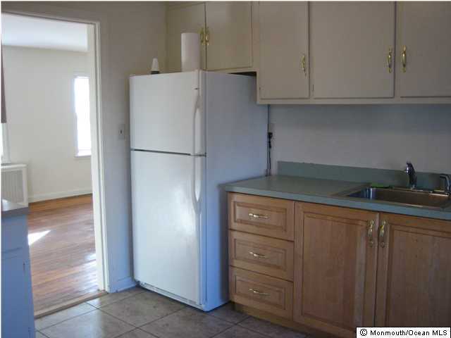 34 Pinckney Road, Unit 34A Red Bank, NJ 07701 - Photo 2 of 3 a white refrigerator freezer sitting inside of a kitchen