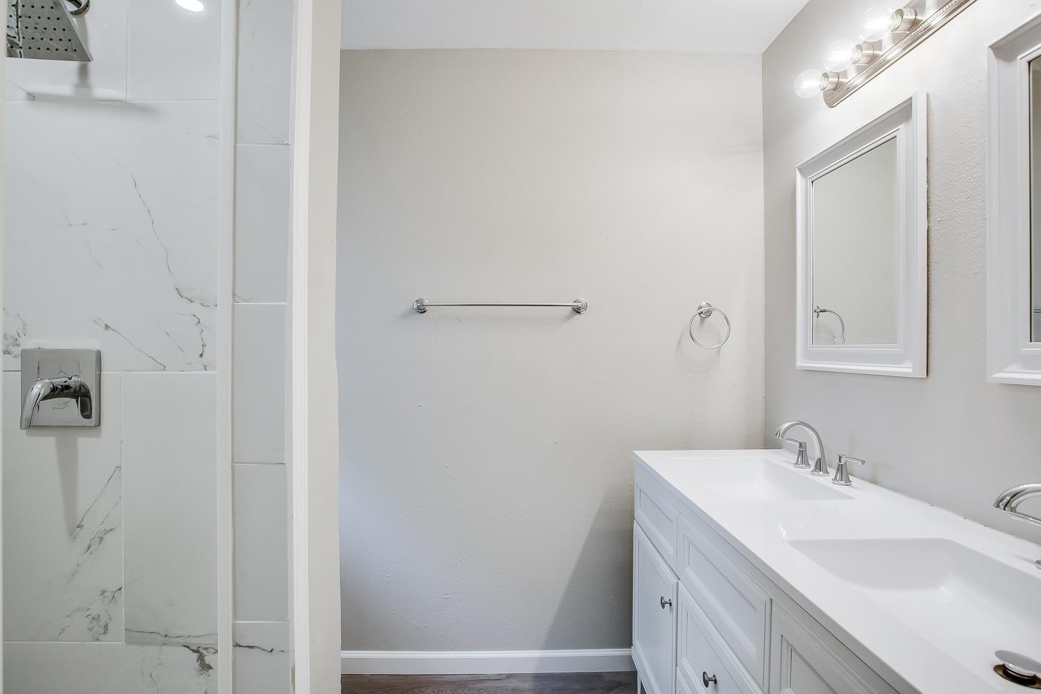 4509 40th Street Lubbock, TX 79414 - Photo 11 of 21 a bathroom with a sink and a mirror