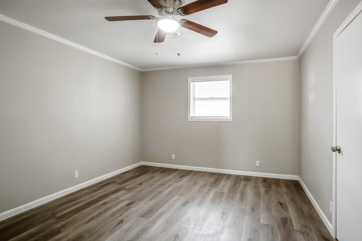 4509 40th Street Lubbock, TX 79414 - Photo 13 of 21 wooden floor in an empty room with a window