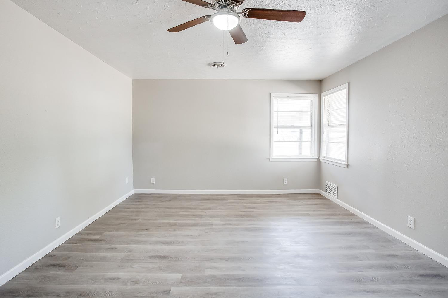 4509 40th Street Lubbock, TX 79414 - Photo 17 of 21 wooden floor in an empty room with a window
