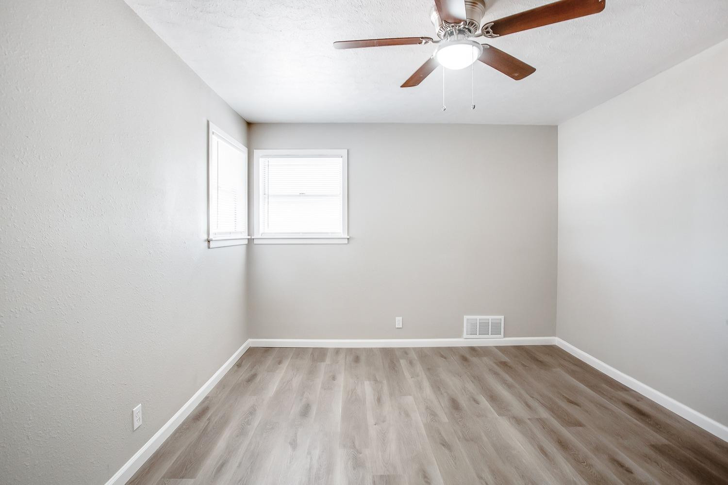 4509 40th Street Lubbock, TX 79414 - Photo 18 of 21 a view of a room with wooden floor and windows