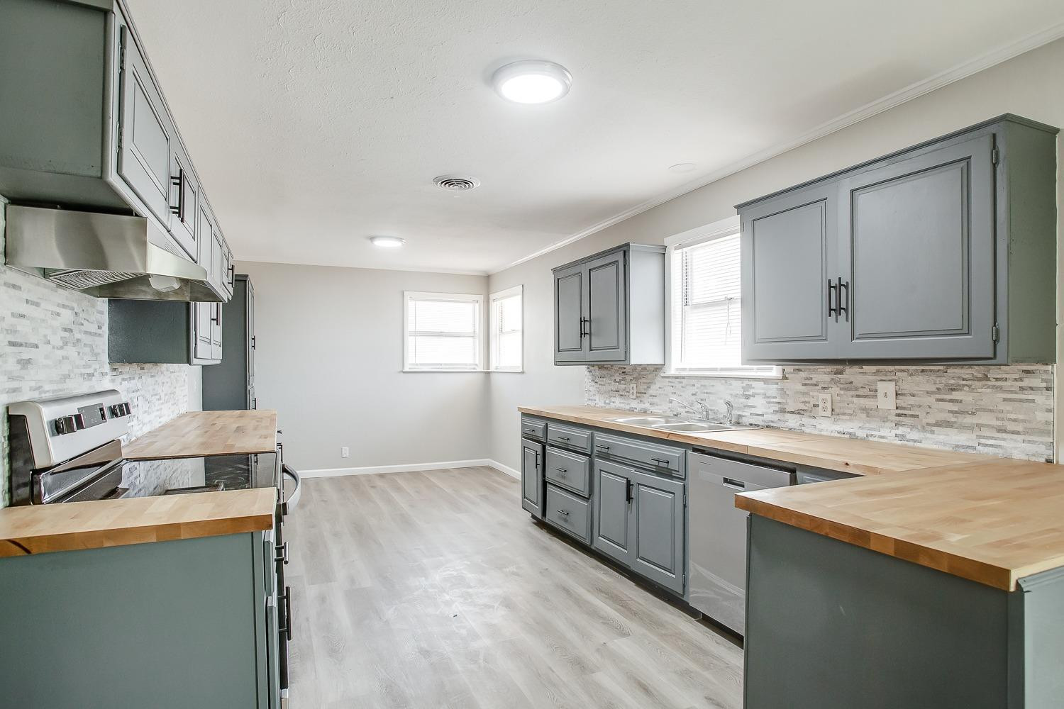 4509 40th Street Lubbock, TX 79414 - Photo 5 of 21 a kitchen with stainless steel appliances granite countertop a sink stove and refrigerator