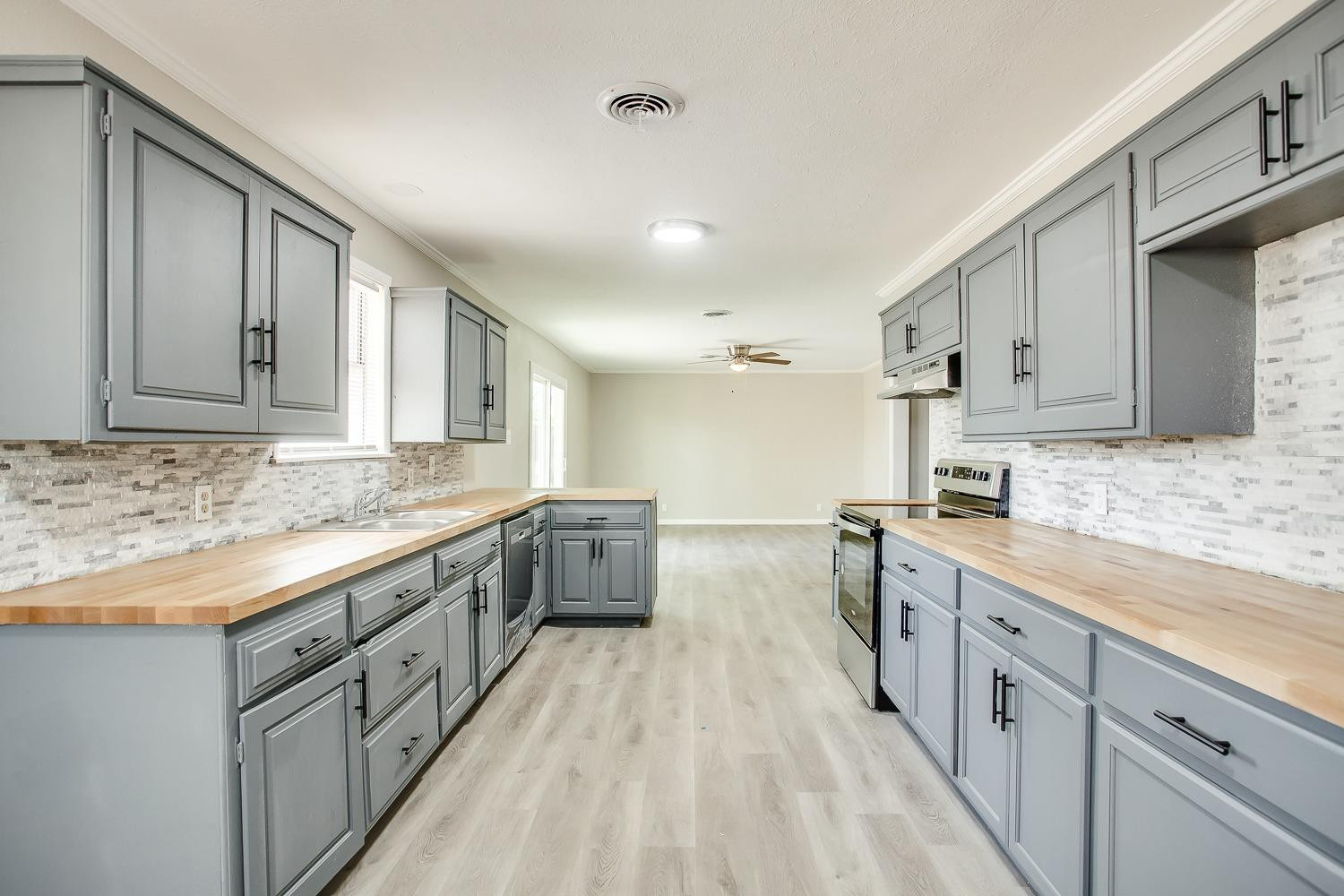 4509 40th Street Lubbock, TX 79414 - Photo 7 of 21 a large kitchen with cabinets
