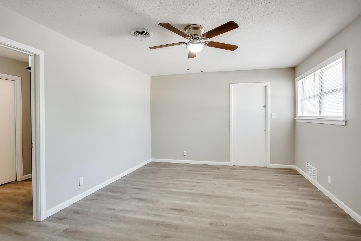 4509 40th Street Lubbock, TX 79414 - Photo 10 of 21 wooden floor in an empty room