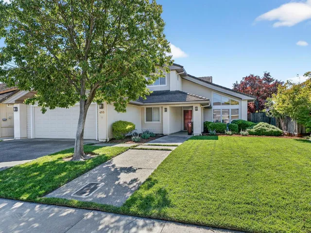 a front view of a house with a yard and garage