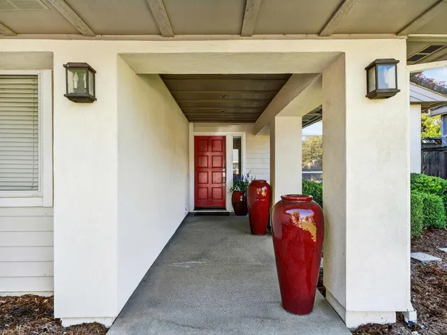 a view of a porch with furniture and front door