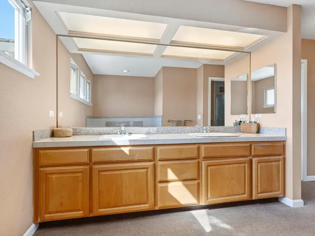 a kitchen with stainless steel appliances cabinets and a window