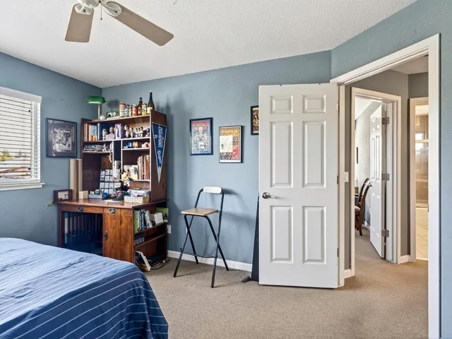 a bathroom with a granite countertop sink a toilet and shower