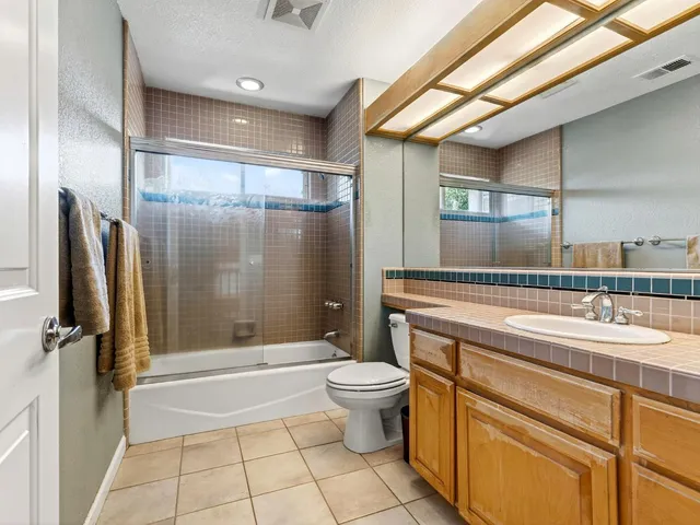 a bedroom with a bed a couch and a window