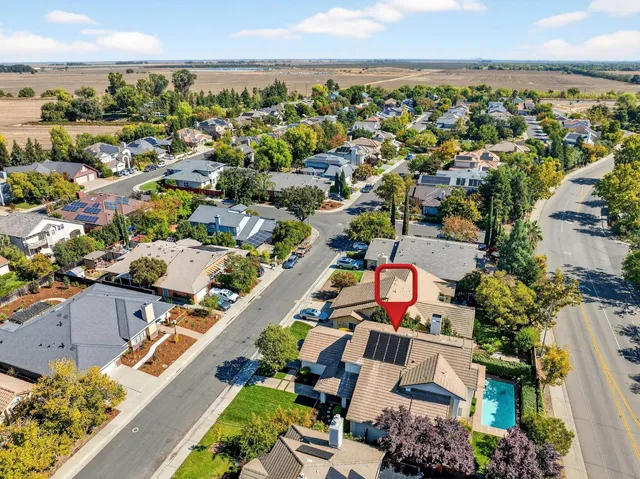 a front view of a house with garden and patio