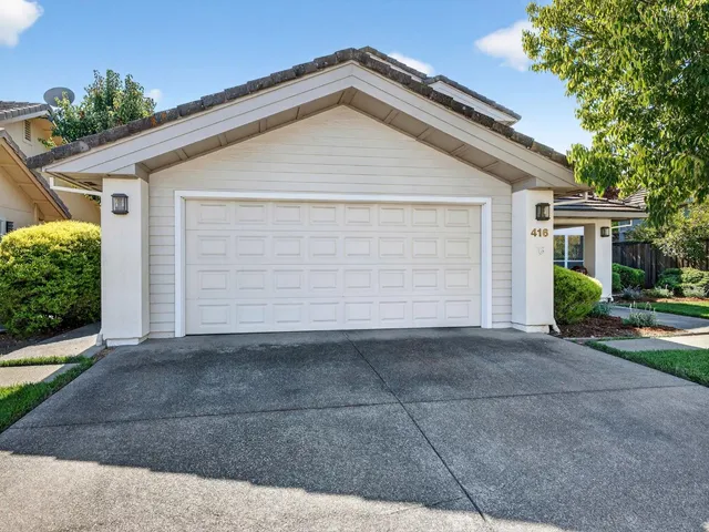 a view of a house with potted plants