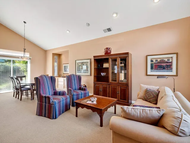 a living room with furniture a rug and a large window