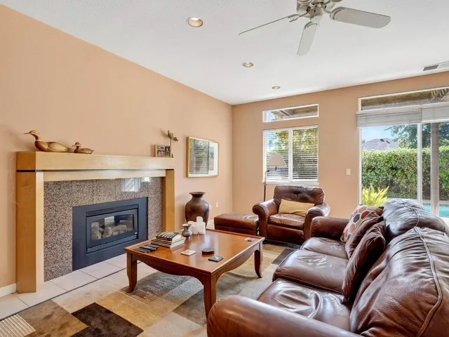 a living room with furniture and large windows