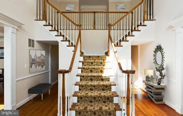 a view of entryway with wooden floor and stairs