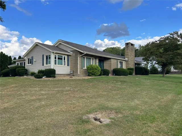 a front view of a house with a garden