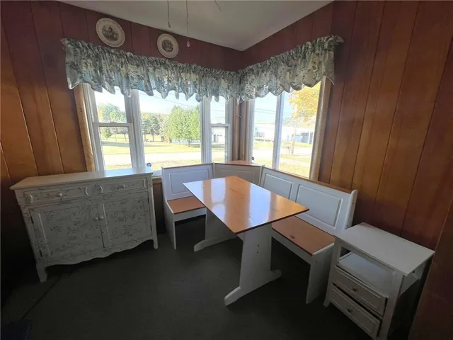 a view of a dining room with furniture and window