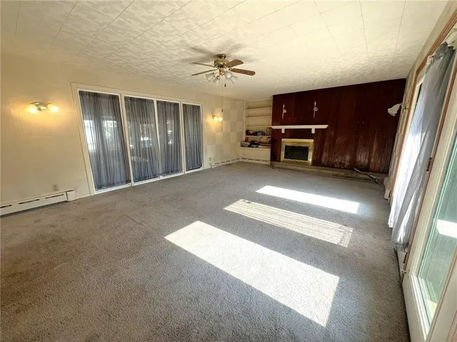a view of a livingroom with furniture and an empty room