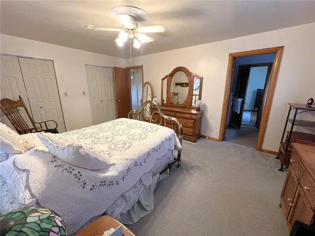 a bed sitting in a bedroom and mirror