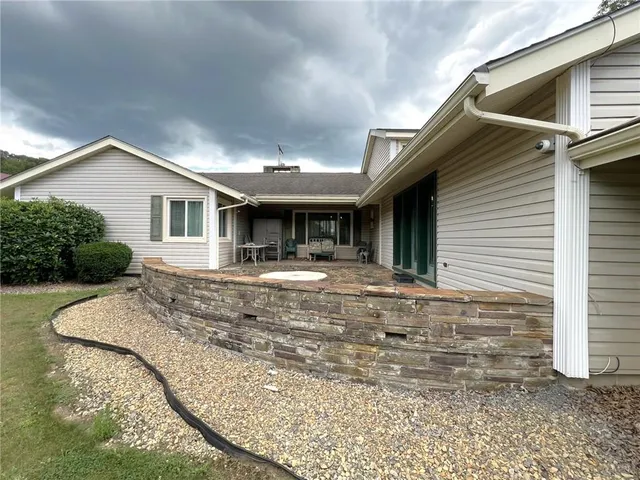 a view of house with yard and sitting area