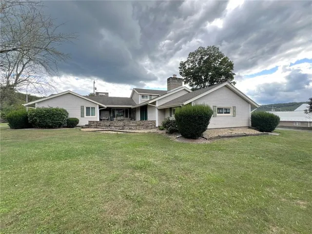a front view of a house with a garden