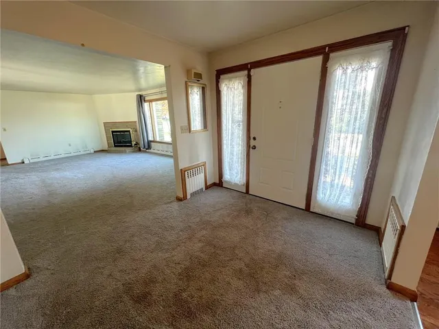 a view of empty room with floor to ceiling window