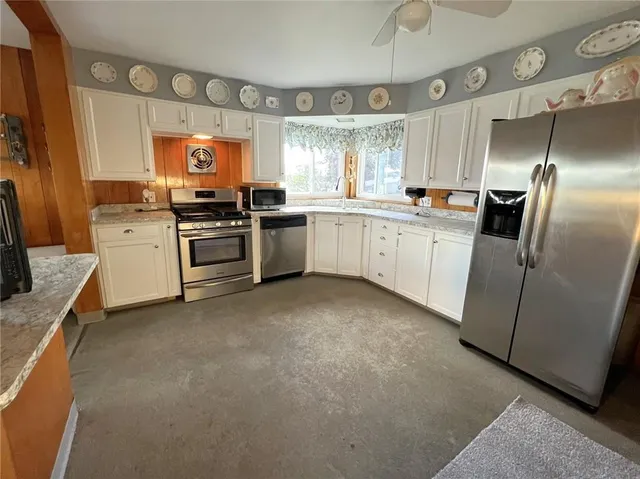 a large kitchen with a large window