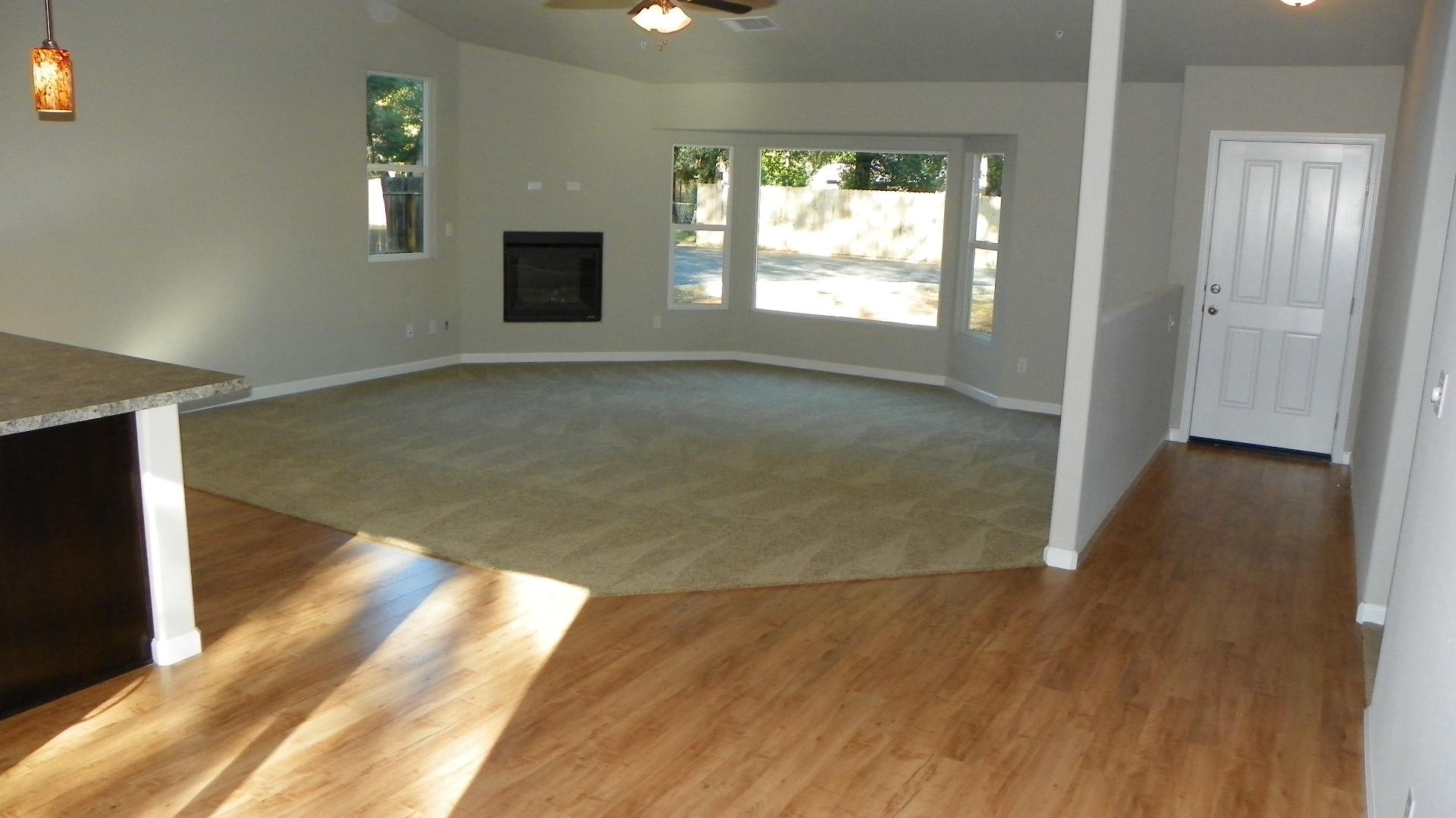 1151 Harpole Road Redding, CA 96002 - Photo 5 of 17 an empty room with wooden floor and windows