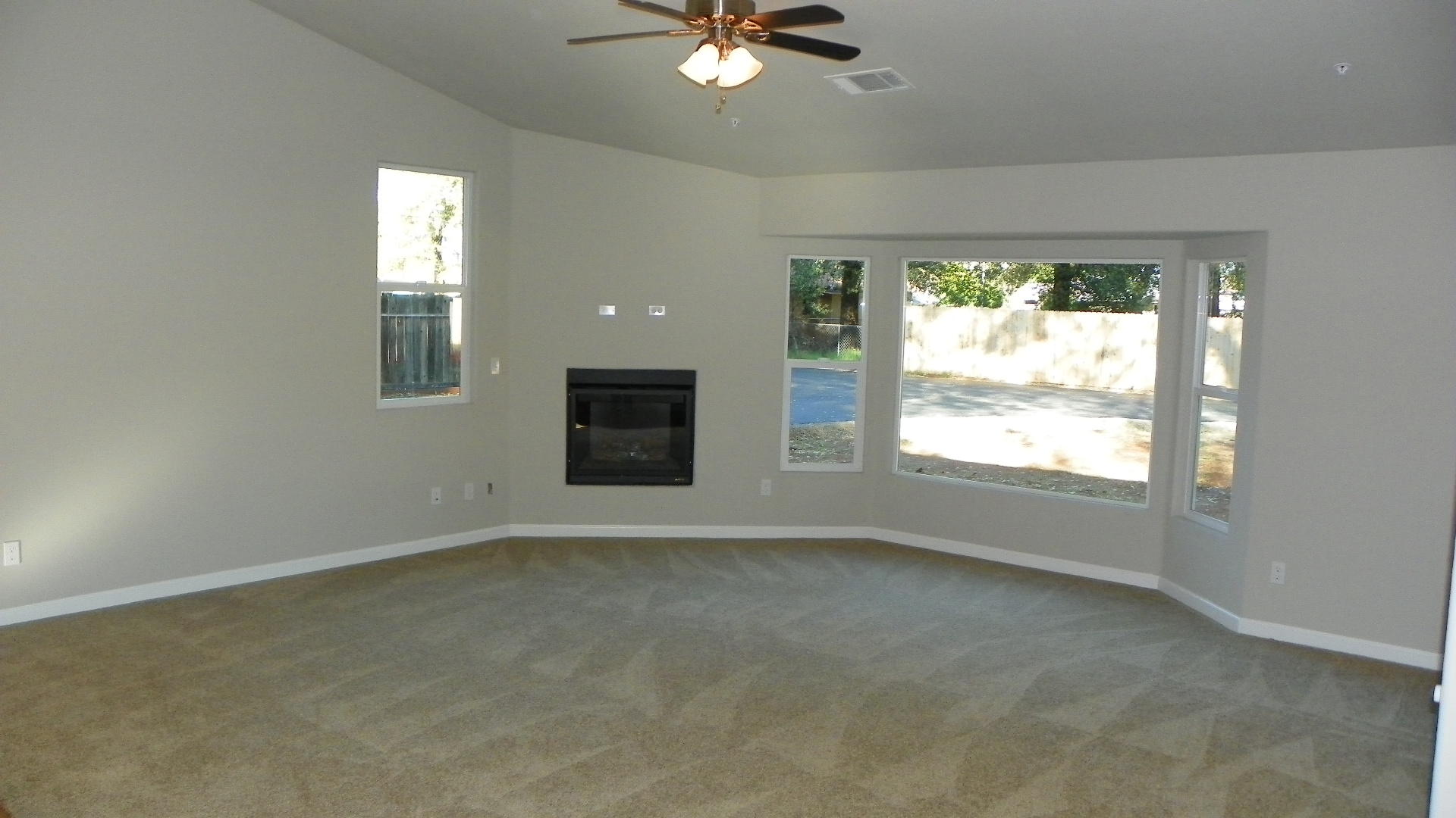 1151 Harpole Road Redding, CA 96002 - Photo 6 of 17 an empty room with a window and a ceiling fan