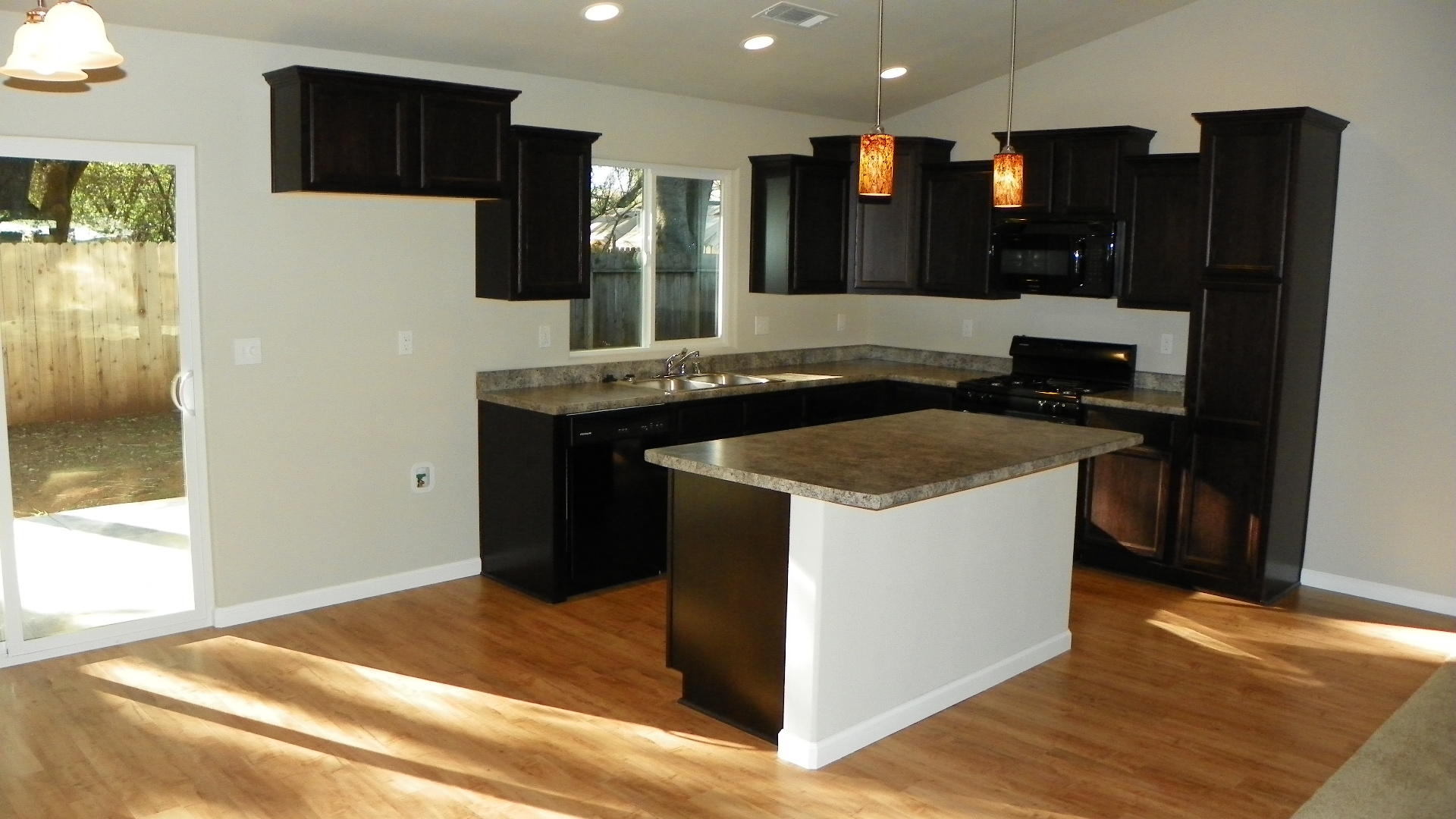 1151 Harpole Road Redding, CA 96002 - Photo 7 of 17 a kitchen with stainless steel appliances granite countertop a stove and a refrigerator