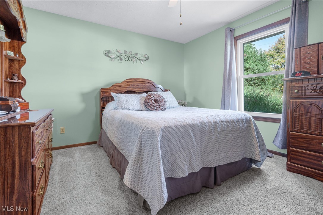 1521 Bravado Road Southwest Canton, OH 44706 - Photo 12 of 37 Bedroom with light carpet and a ceiling fan