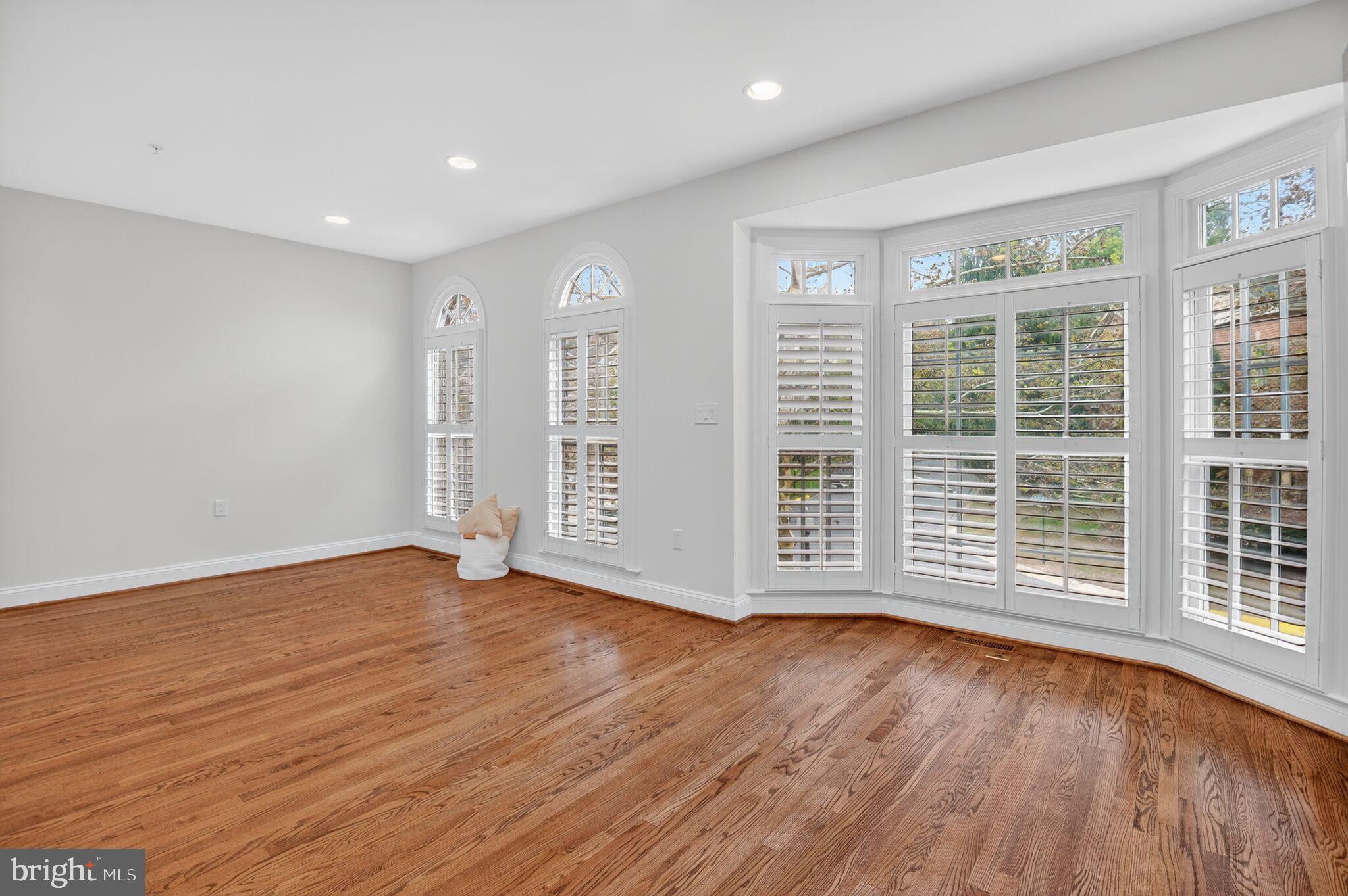 4015 Mansion Drive Northwest Washington, DC 20007 - Photo 12 of 34 a view of an empty room with wooden floor and a window