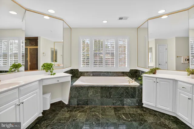 a bathroom with a shower sink and mirror