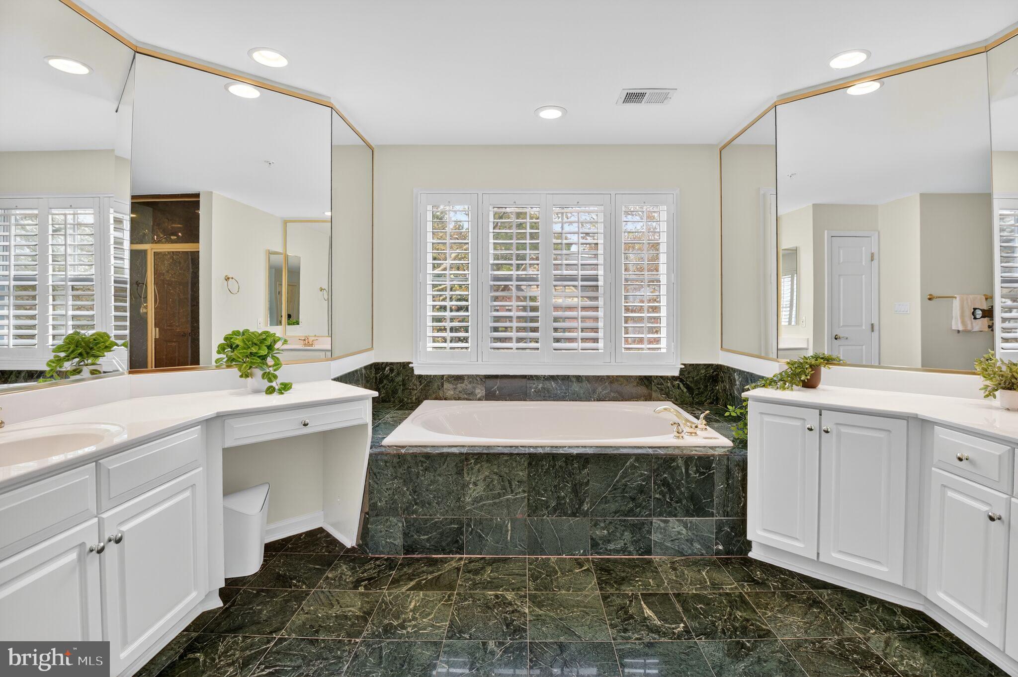 4015 Mansion Drive Northwest Washington, DC 20007 - Photo 16 of 34 a spacious bathroom with a large tub sink and mirror