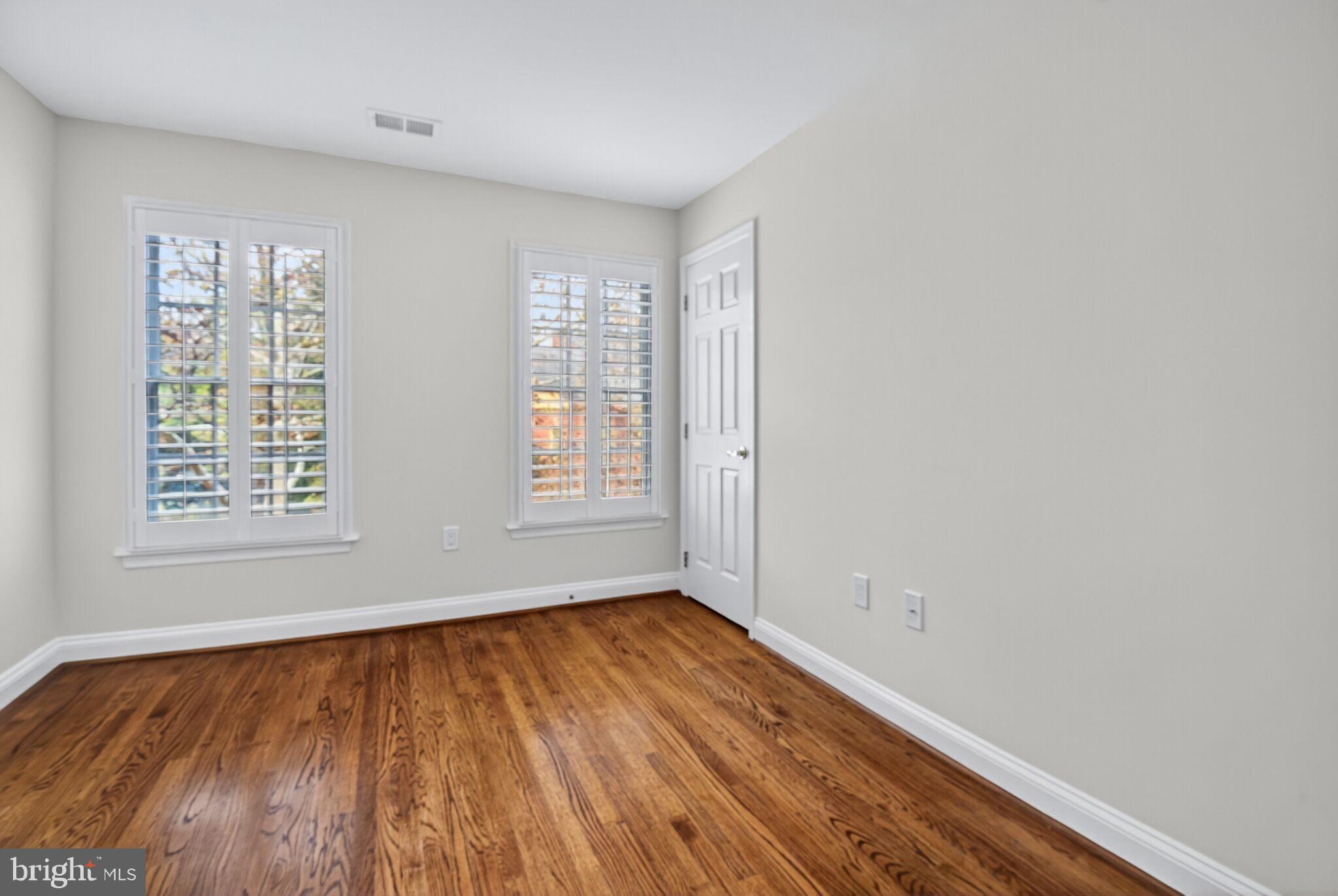 4015 Mansion Drive Northwest Washington, DC 20007 - Photo 19 of 34 an empty room with wooden floor and windows