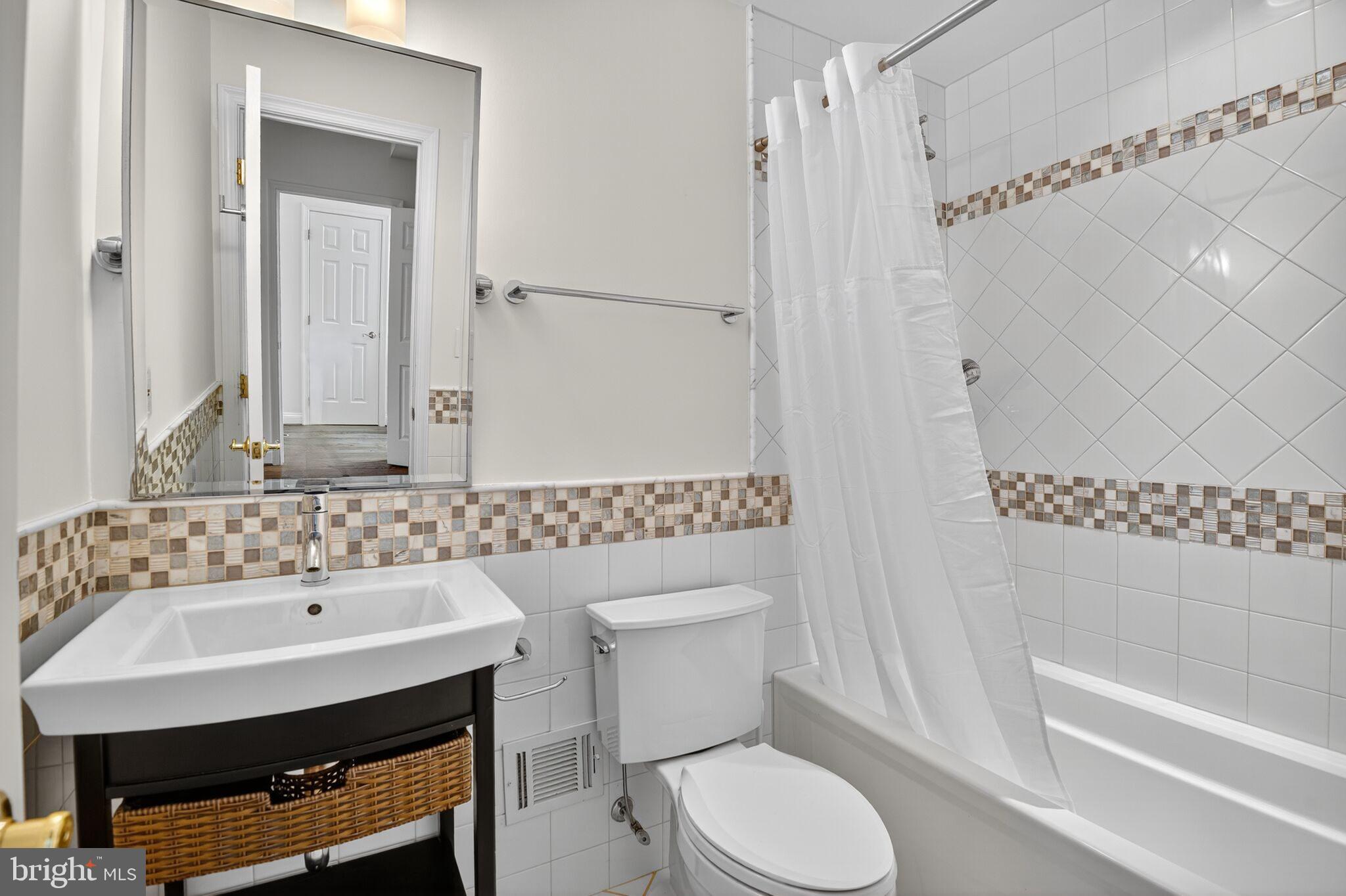 4015 Mansion Drive Northwest Washington, DC 20007 - Photo 24 of 34 a bathroom with a sink a toilet and shower