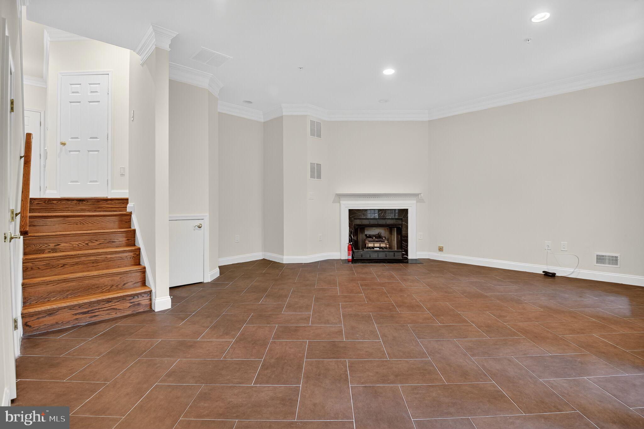 4015 Mansion Drive Northwest Washington, DC 20007 - Photo 26 of 34 a view of an empty room with wooden floor and a fireplace