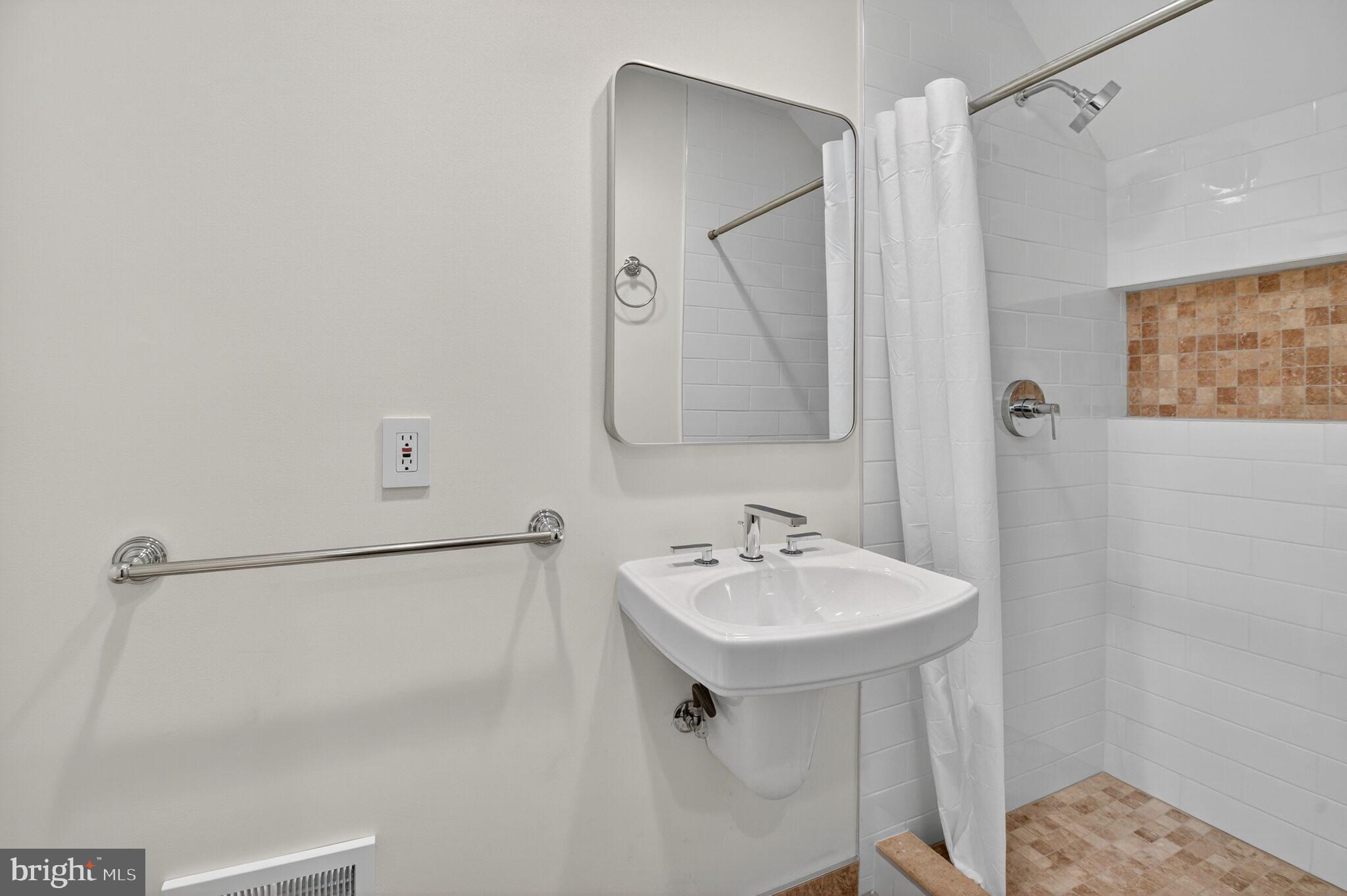 4015 Mansion Drive Northwest Washington, DC 20007 - Photo 27 of 34 a bathroom with a sink and a mirror