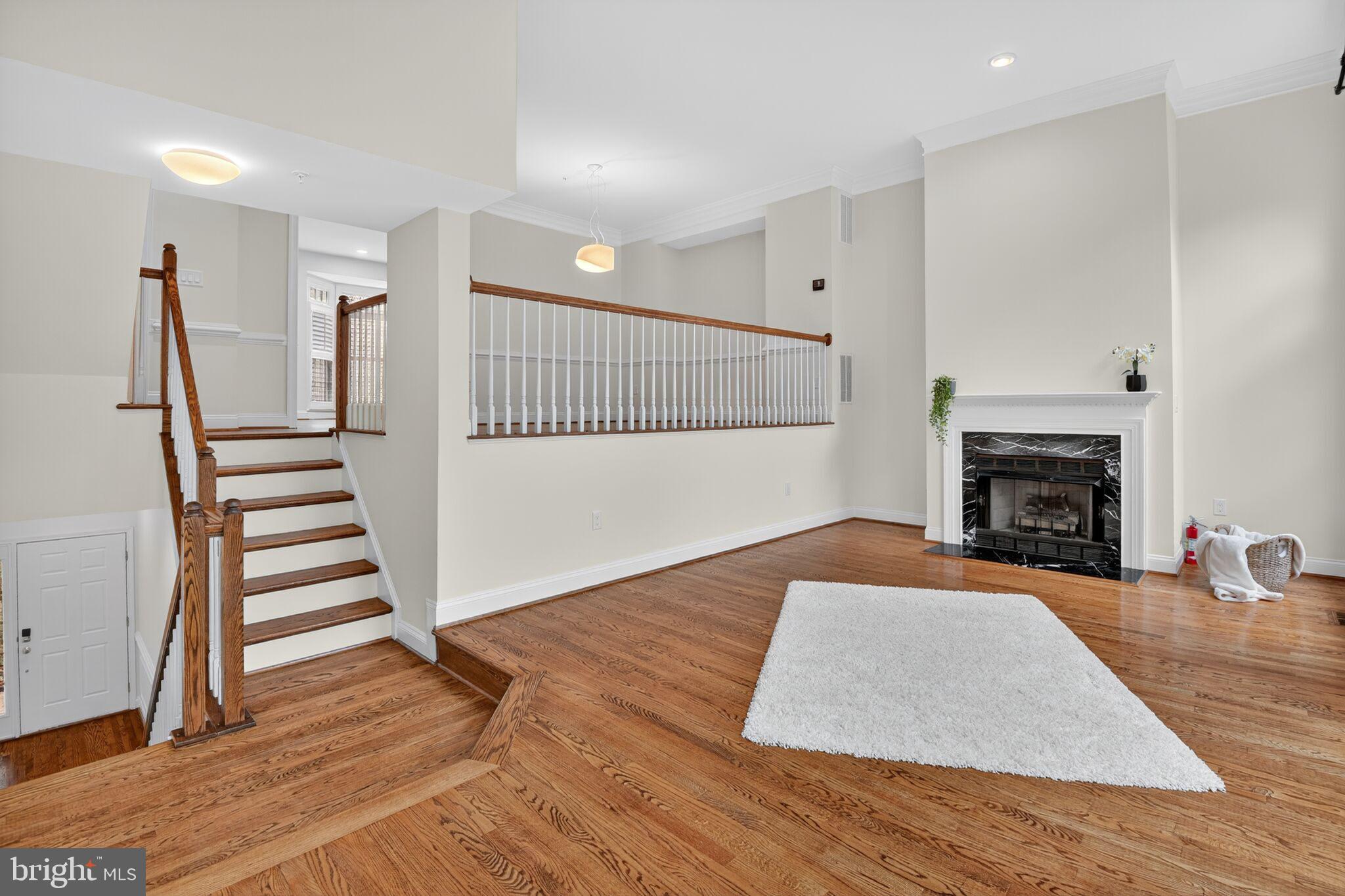 4015 Mansion Drive Northwest Washington, DC 20007 - Photo 4 of 34 a view of a livingroom with wooden floor and a fireplace