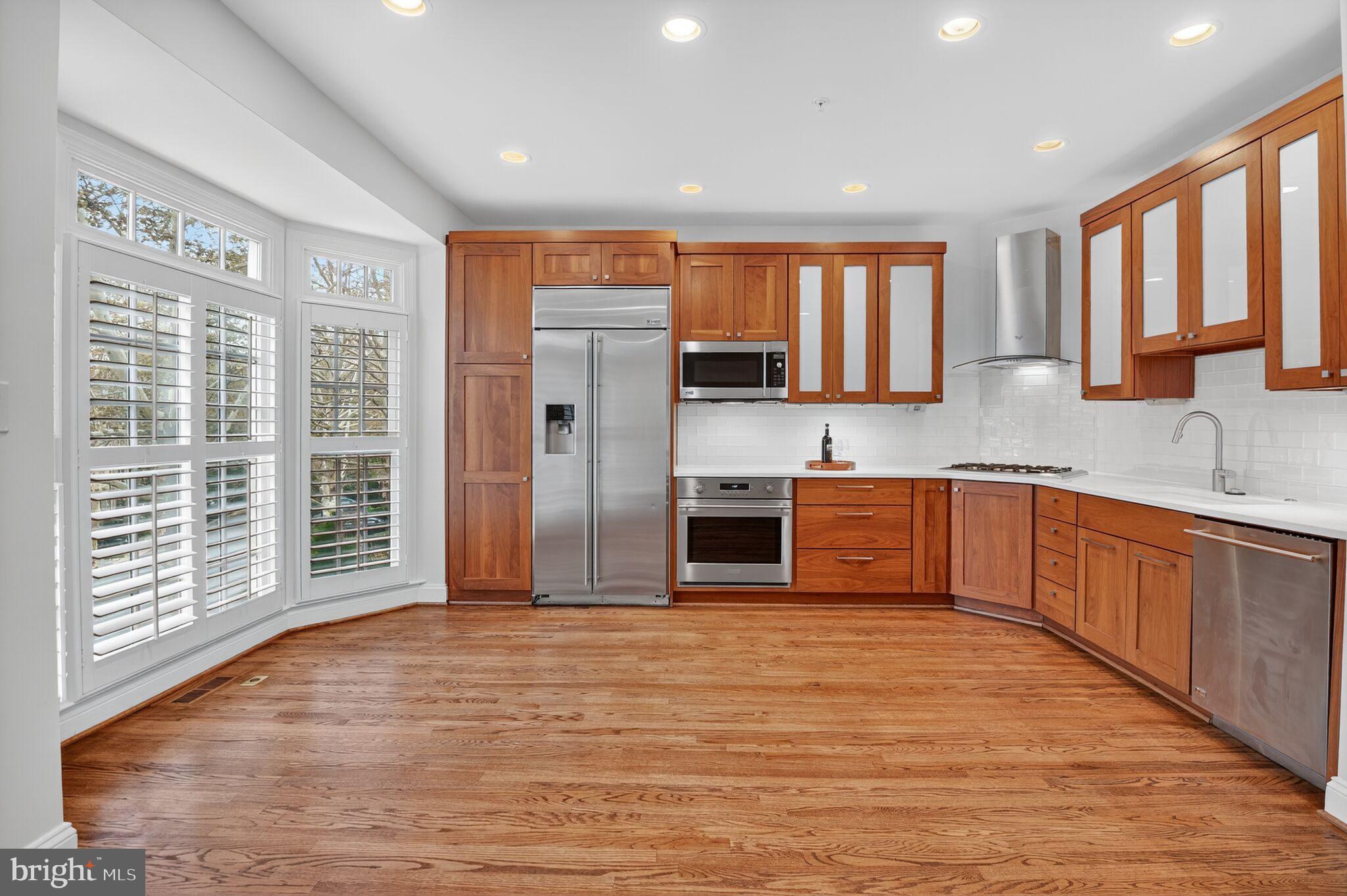 4015 Mansion Drive Northwest Washington, DC 20007 - Photo 10 of 34 a large kitchen with stainless steel appliances granite countertop a refrigerator and a sink