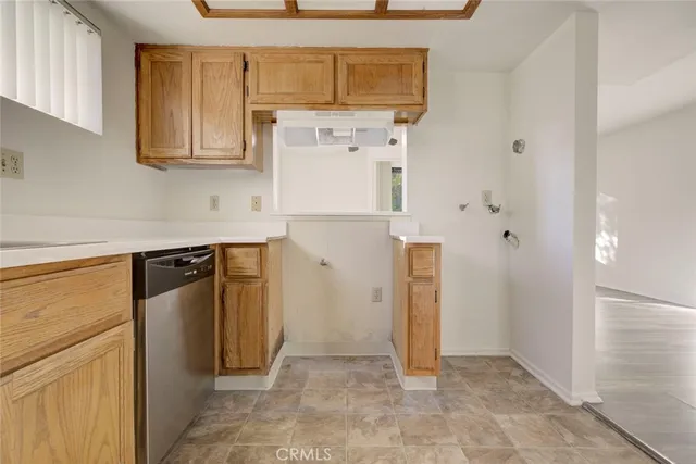 a view of a kitchen with refrigerator and cabinets