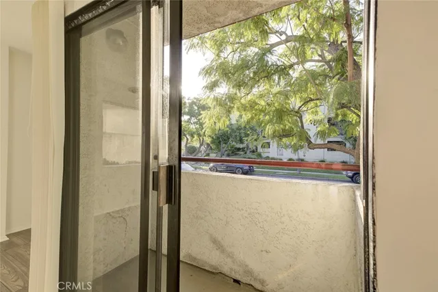 a view of a glass door with a yard from a window