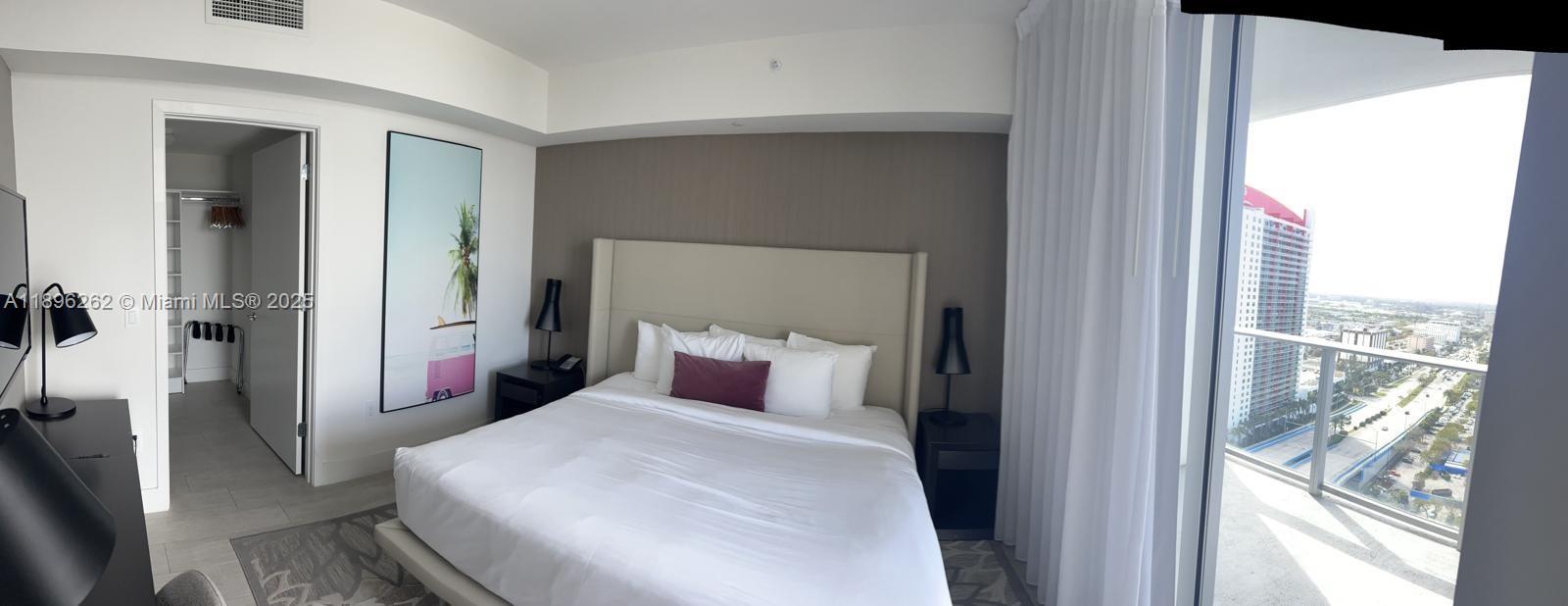 4010 South Ocean Drive, Unit R2004 Hollywood, FL 33019 - Photo 12 of 34 a bedroom with a large bed and a large window