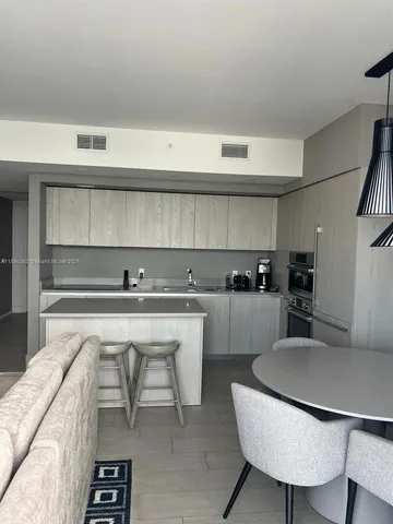 a kitchen with a table and chairs in it