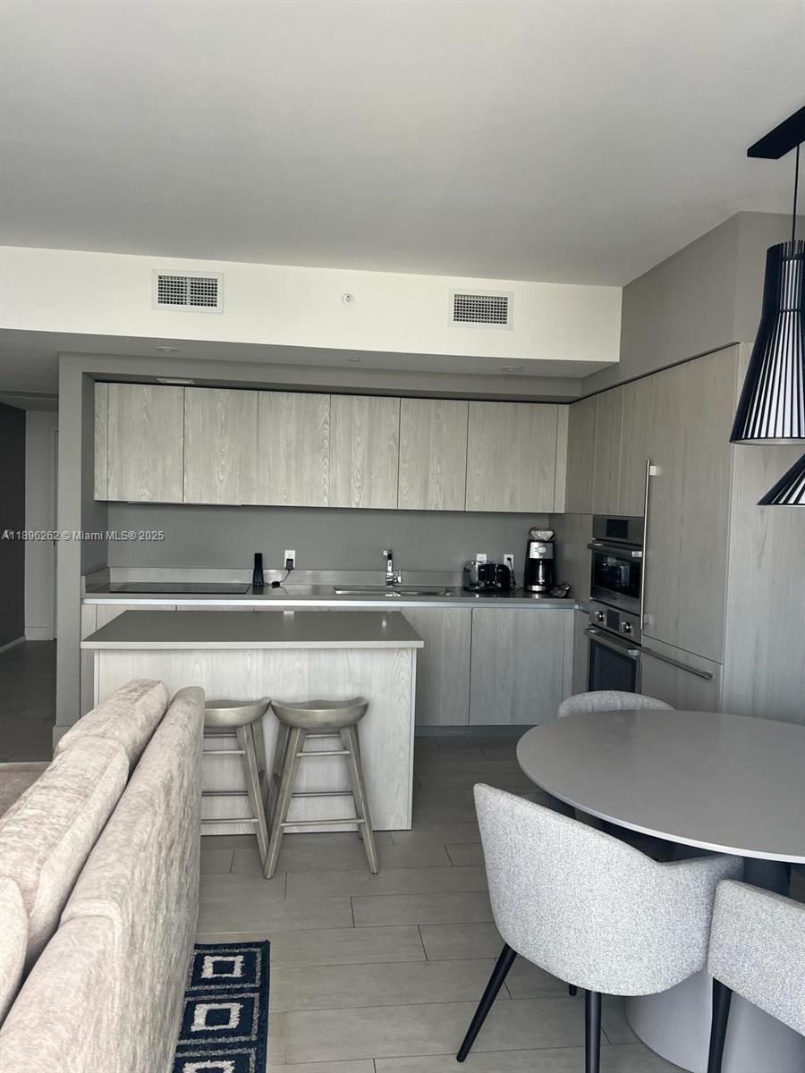 4010 South Ocean Drive, Unit R2004 Hollywood, FL 33019 - Photo 19 of 34 a kitchen with a table and chairs in it