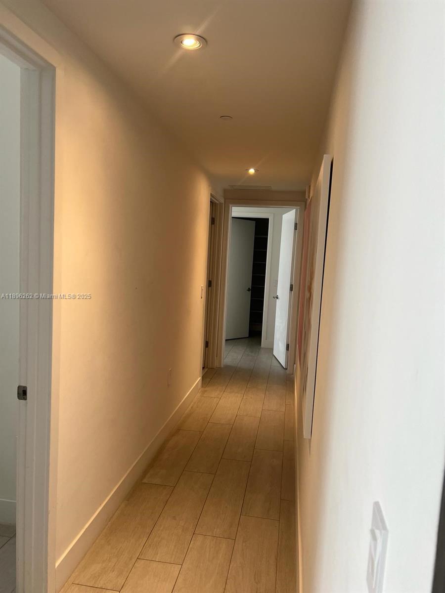 4010 South Ocean Drive, Unit R2004 Hollywood, FL 33019 - Photo 3 of 34 a view of a hallway with wooden floor