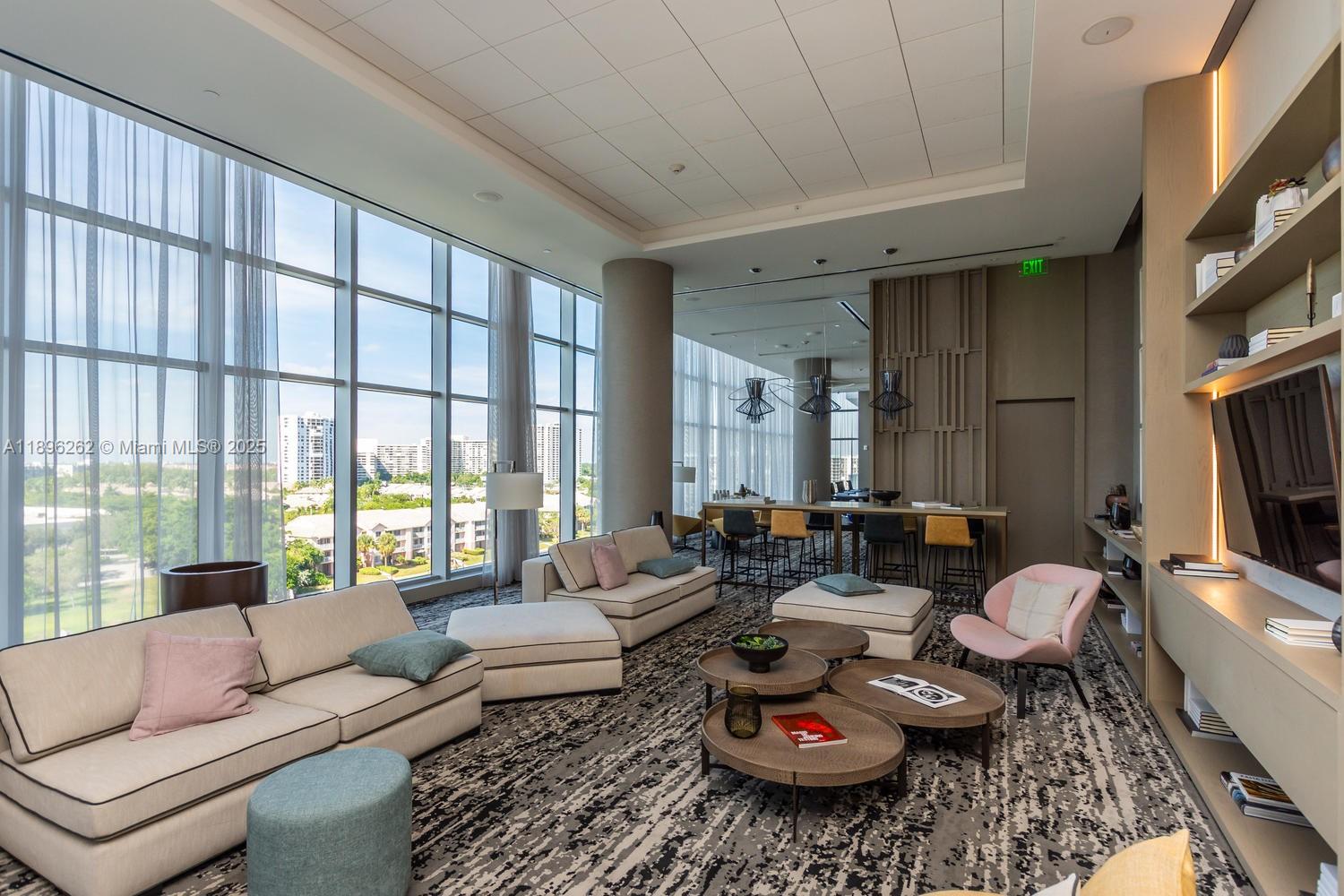 4010 South Ocean Drive, Unit R2004 Hollywood, FL 33019 - Photo 31 of 34 a living room with furniture and a flat screen tv