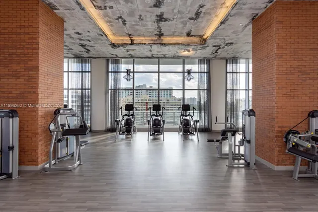 a lobby with furniture and floor to ceiling window