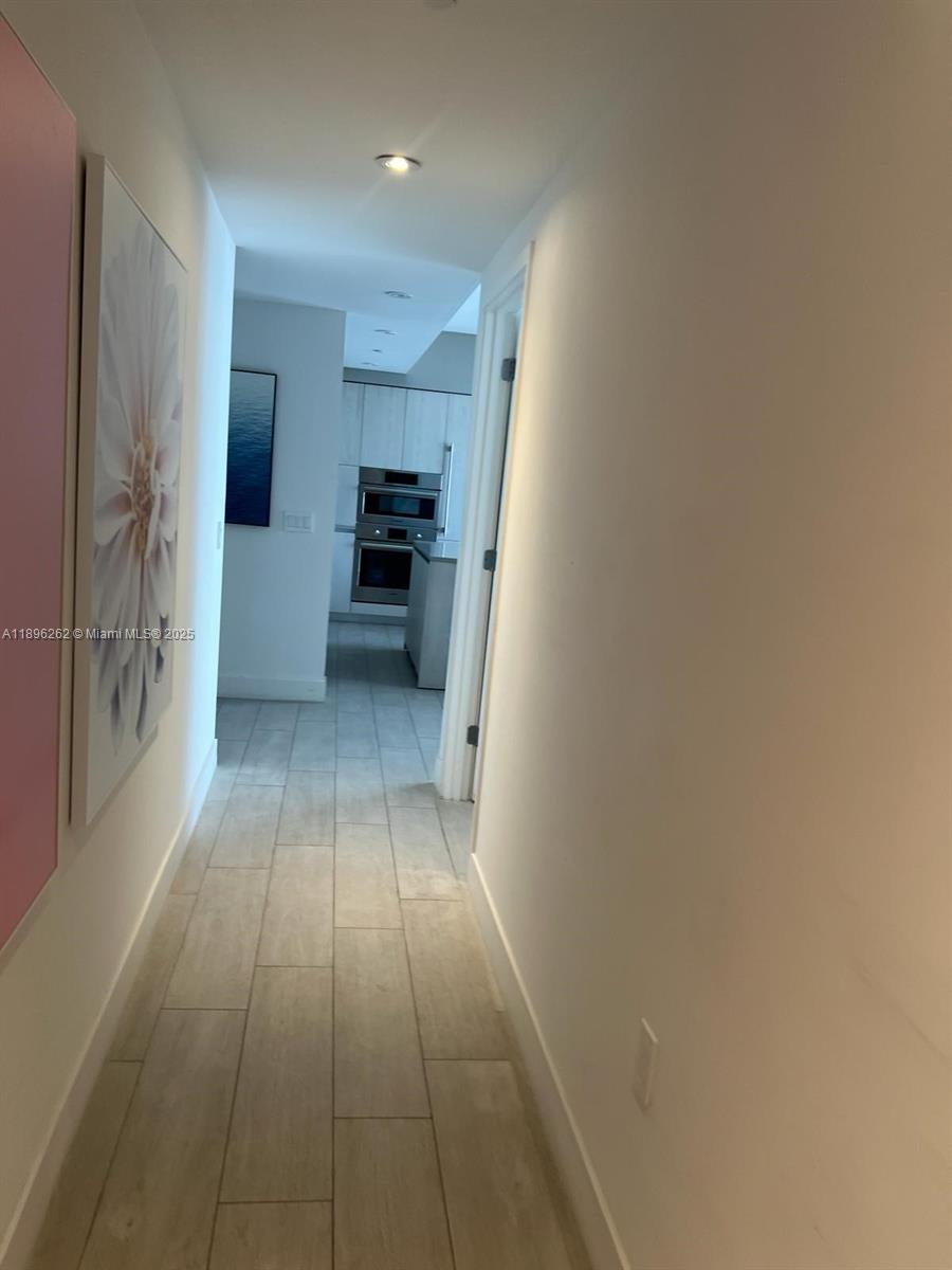 4010 South Ocean Drive, Unit R2004 Hollywood, FL 33019 - Photo 9 of 34 a view of a kitchen with a sink and a refrigerator