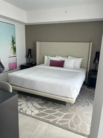 a bedroom with a bed and dresser